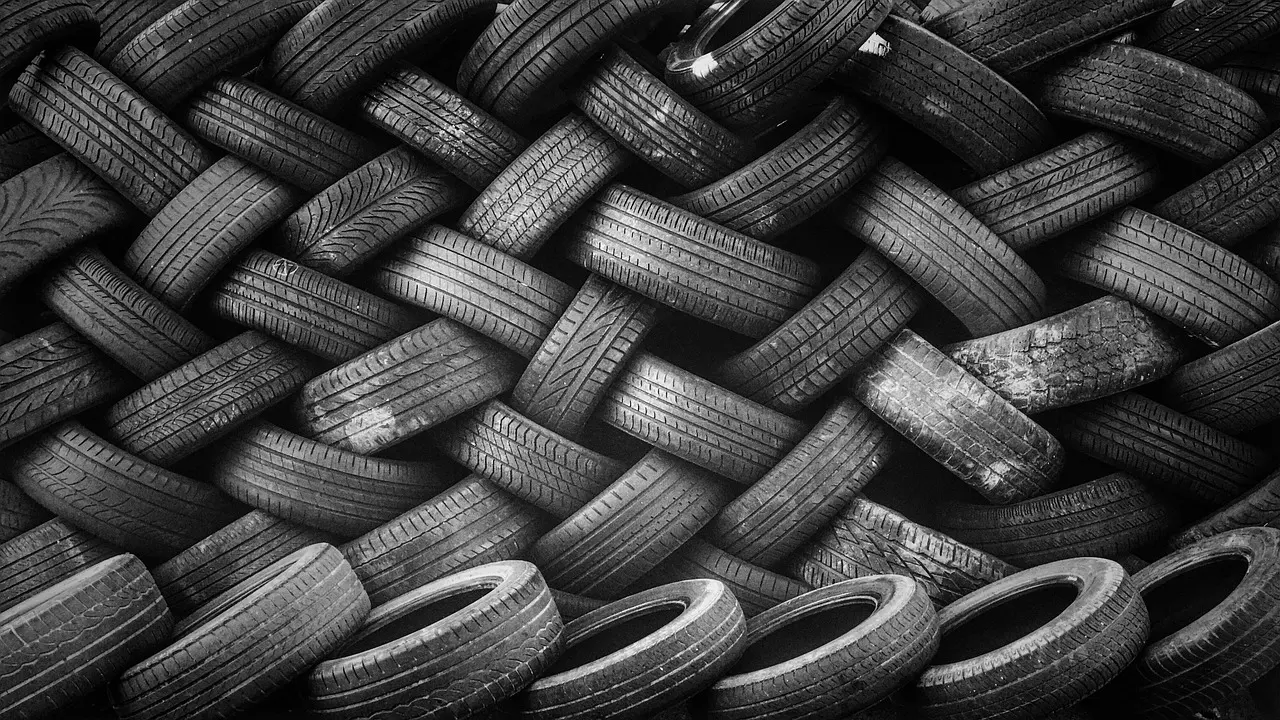 Pile of used tires stacked together